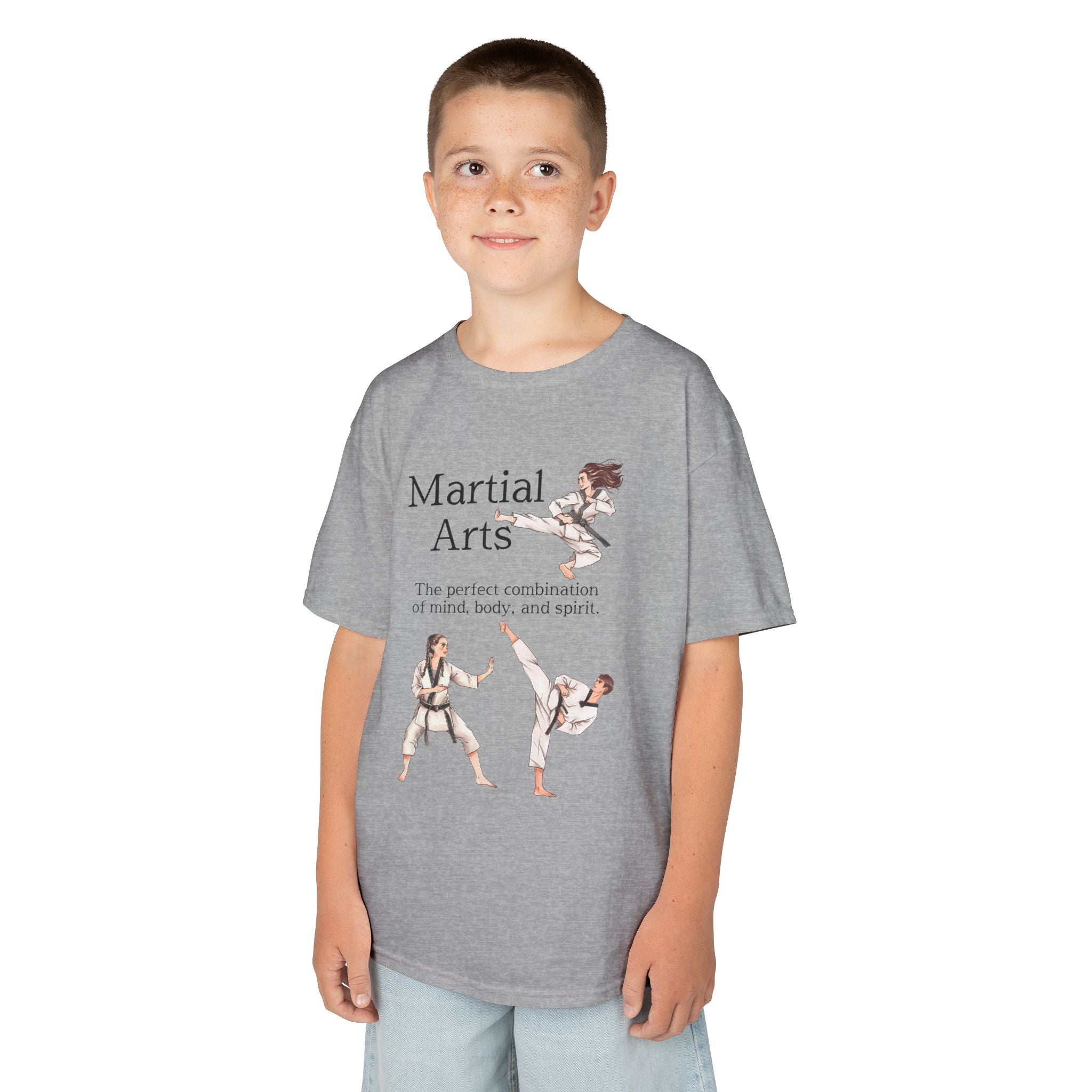 Young boy wearing a youth Gildan 5000B heavy cotton t-shirt in sport grey with a Martial Arts text and graphic