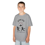 Young boy wearing a youth Gildan 5000B heavy cotton t-shirt in sport grey with a Bowling text and graphic