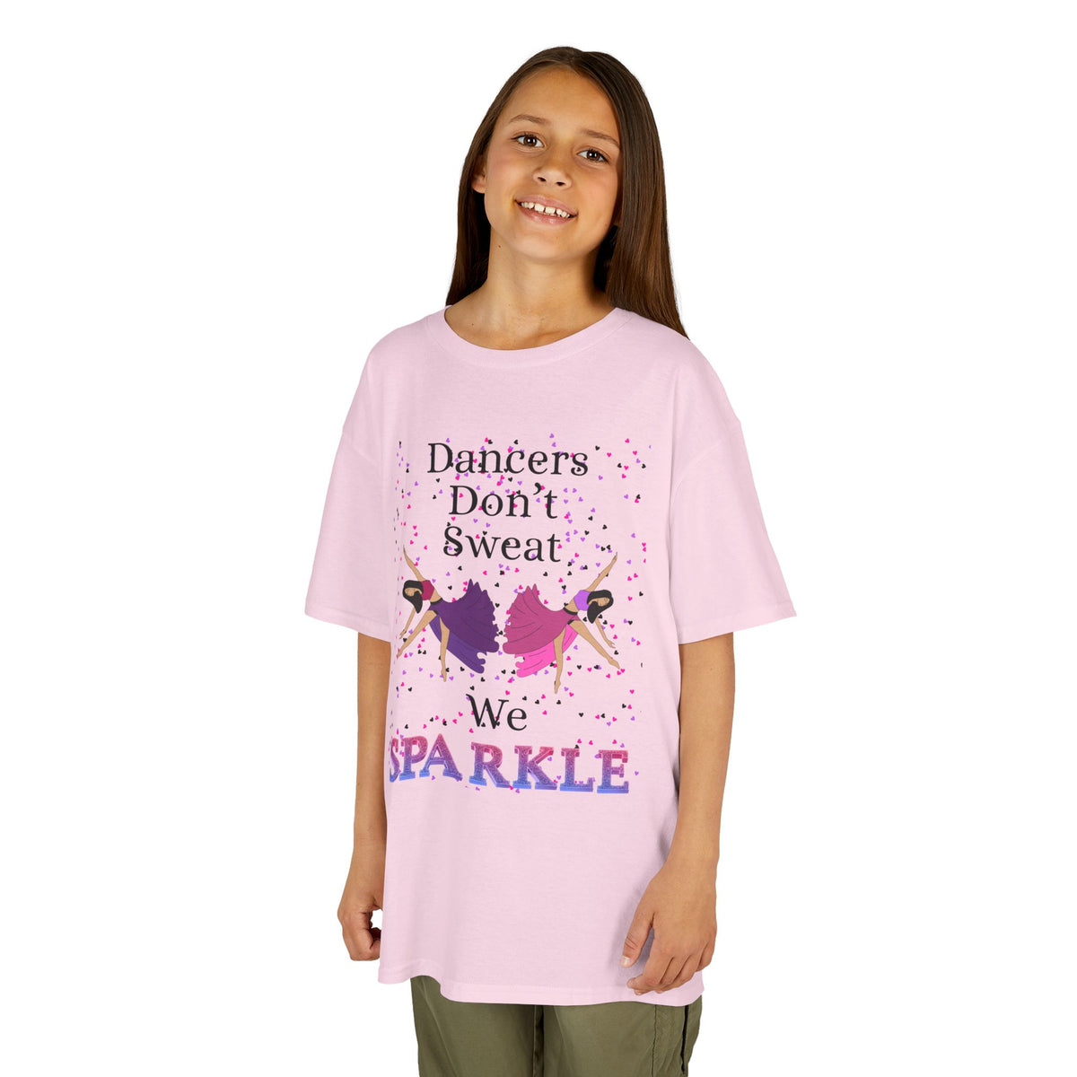 Young girl wearing a youth Gildan 5000B heavy cotton t-shirt in light pink with a Dancer's Don't Sweat We Sparkle text and graphic