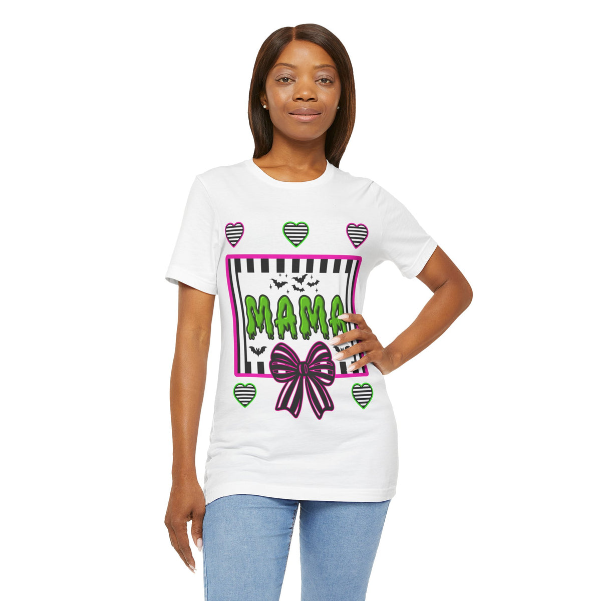 A woman wearing a white t-shirt featuring a colorful Beetlejuice inspired Halloween-themed graphic with MAMA on the front.