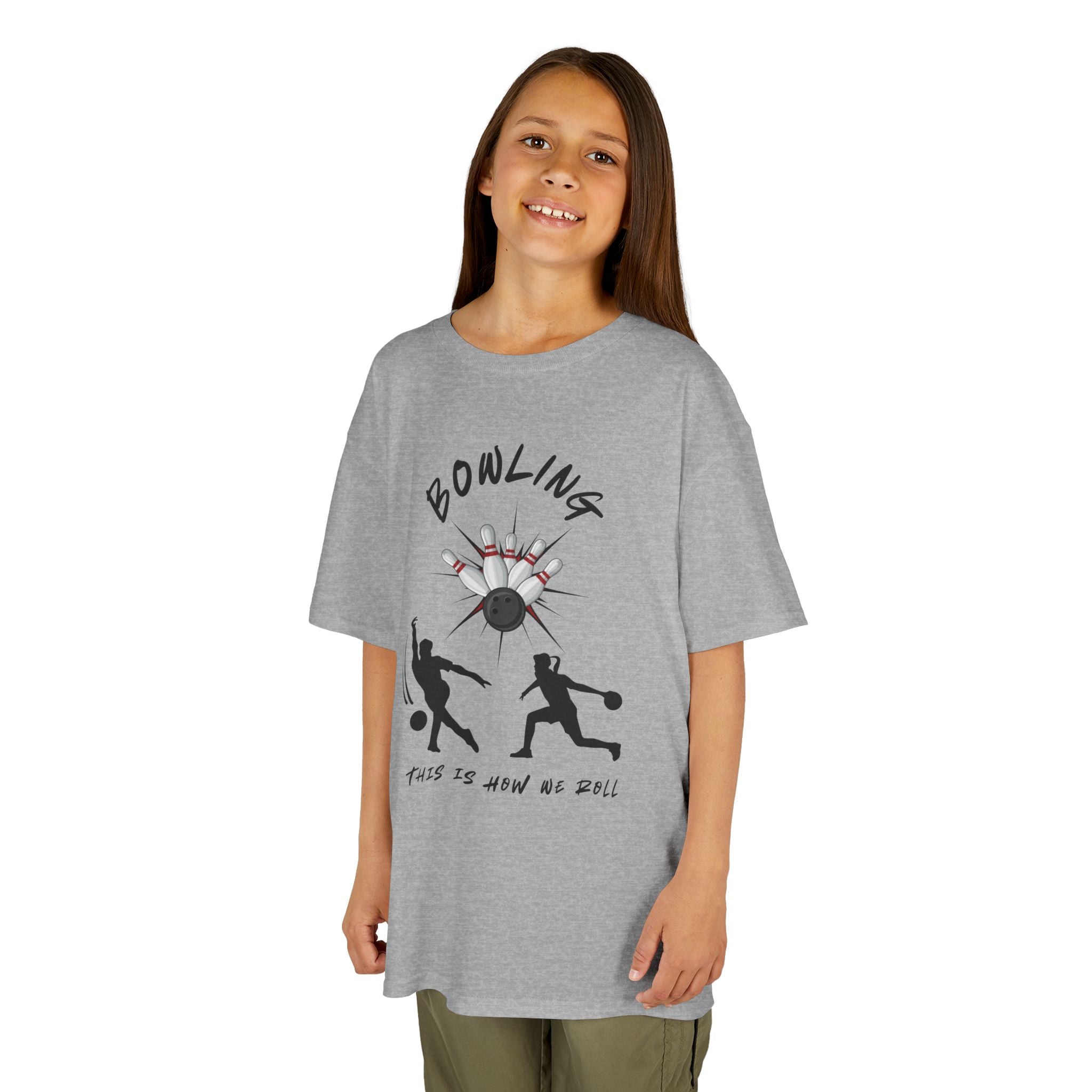 Young girl wearing a youth Gildan 5000B heavy cotton t-shirt in sport grey with a Bowling text and graphic