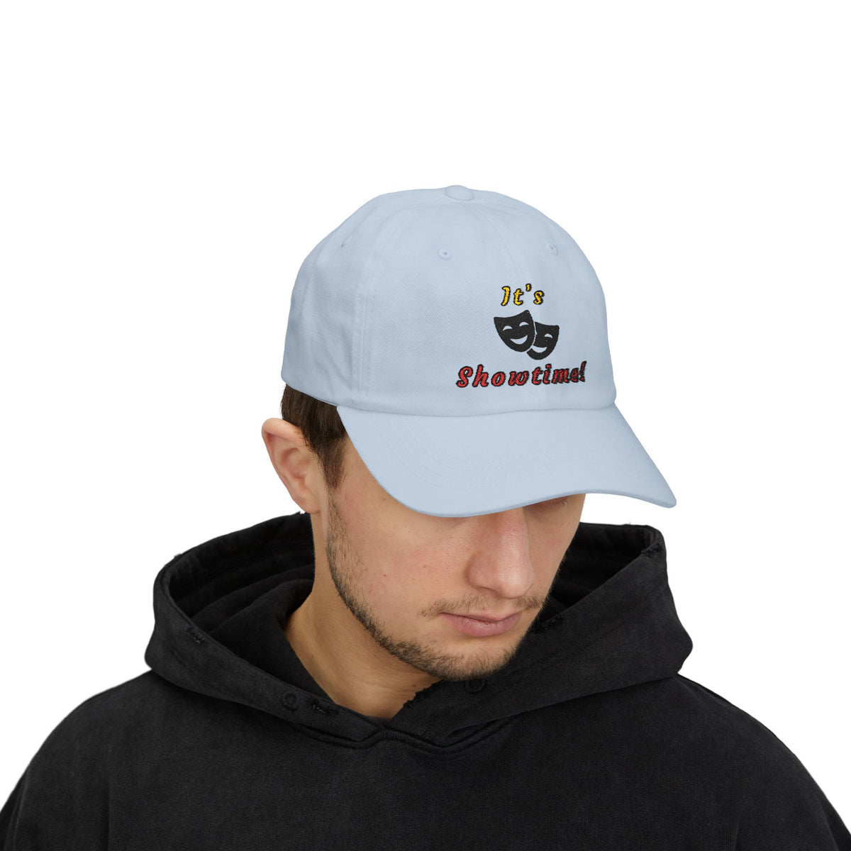 Man wearing a light blue embroidered classic dad cap hat with an It's Showtime text and graphic 