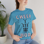A woman wearing a heather aqua graphic t-shirt with CHEER GO TEAM MOM text and graphic on the front.