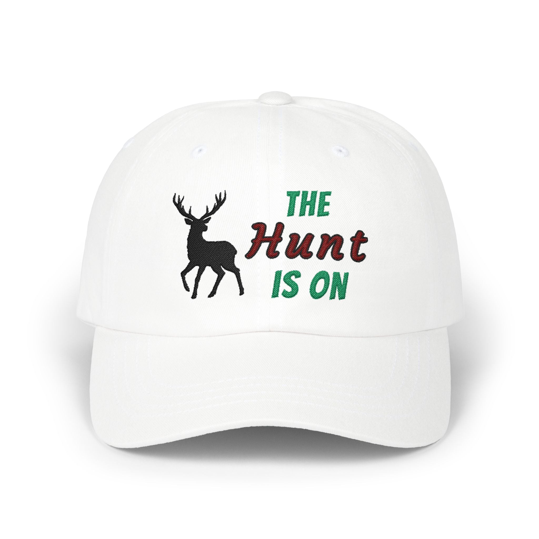 White cap with an embroidered deer silhouette and The Hunt Is On text.