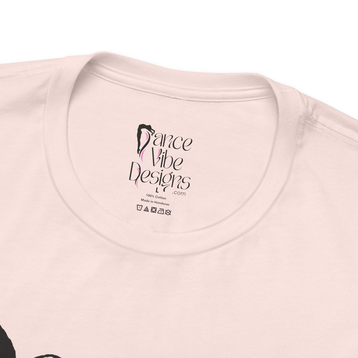 Close-up of a crewneck t-shirt showing the inner neck label with the brand Dance Vibe Designs printed above the care instructions.