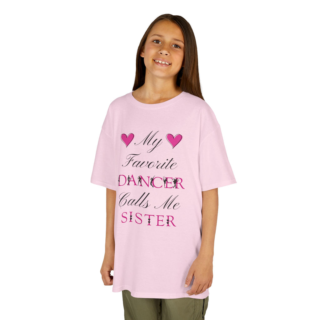 Young girl wearing a light pink short-sleeve t-shirt with a graphic text print on the front that reads My Favorite Dancer Calls Me Sister.