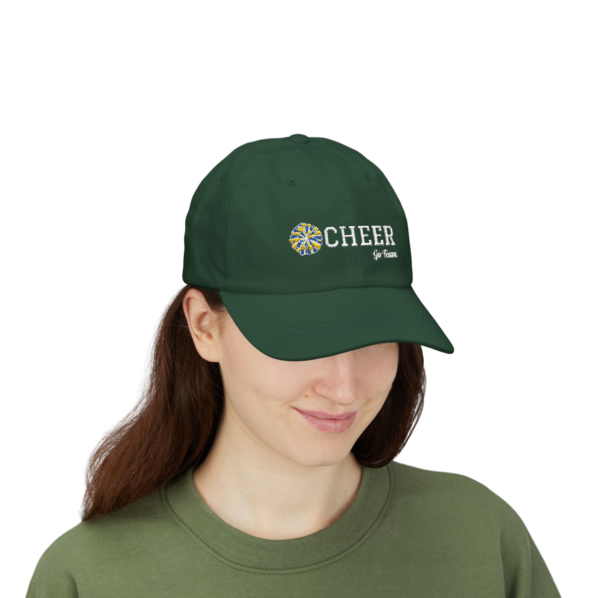 Woman wearing a spruce cap with CHEER Go Team text and logo embroidery.