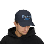 Man wearing a navy embroidered classic dad cap hat with a Dance Dad text and graphic