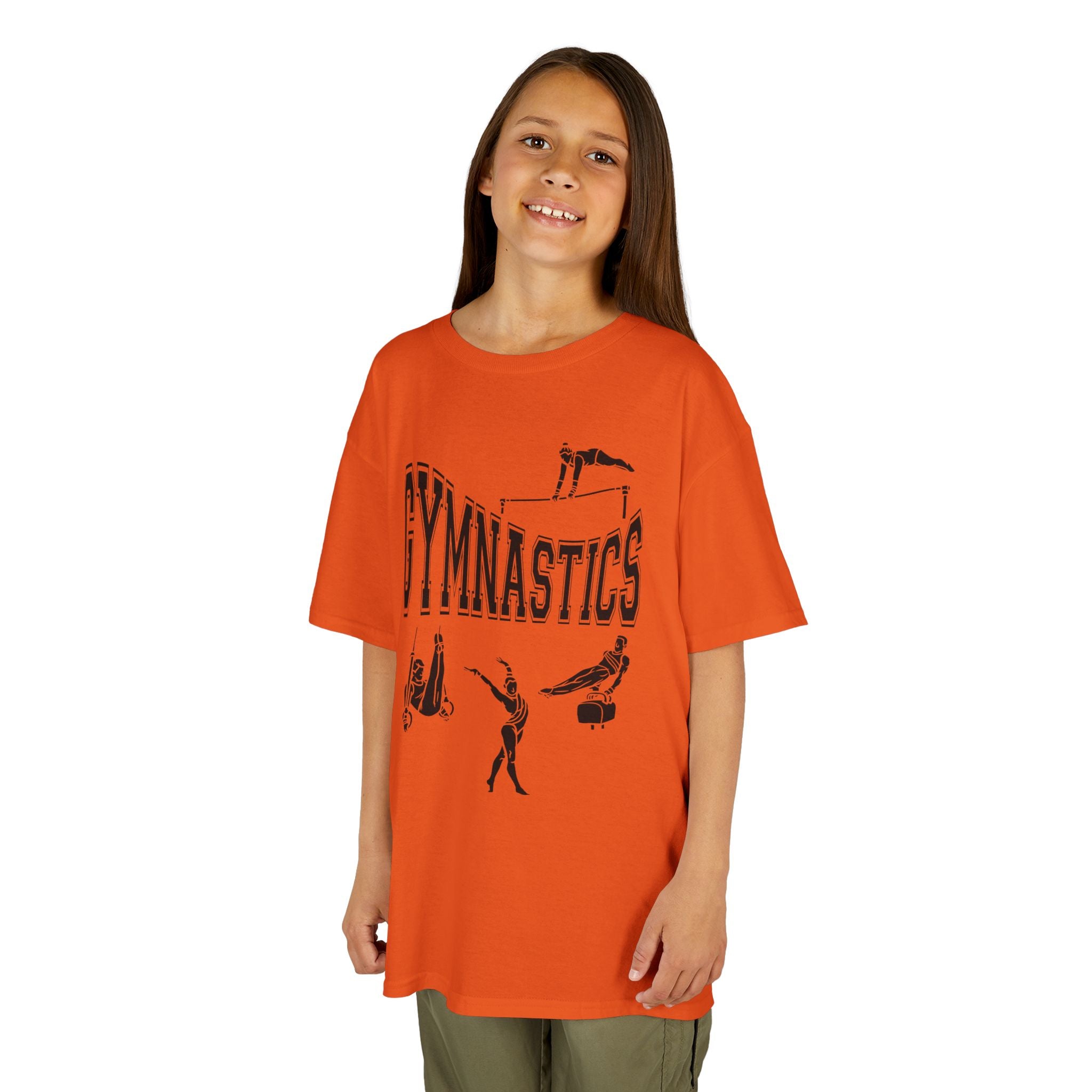 Young girl wearing a youth Gildan 5000B heavy cotton t-shirt in orange with a gymnastics text and graphic