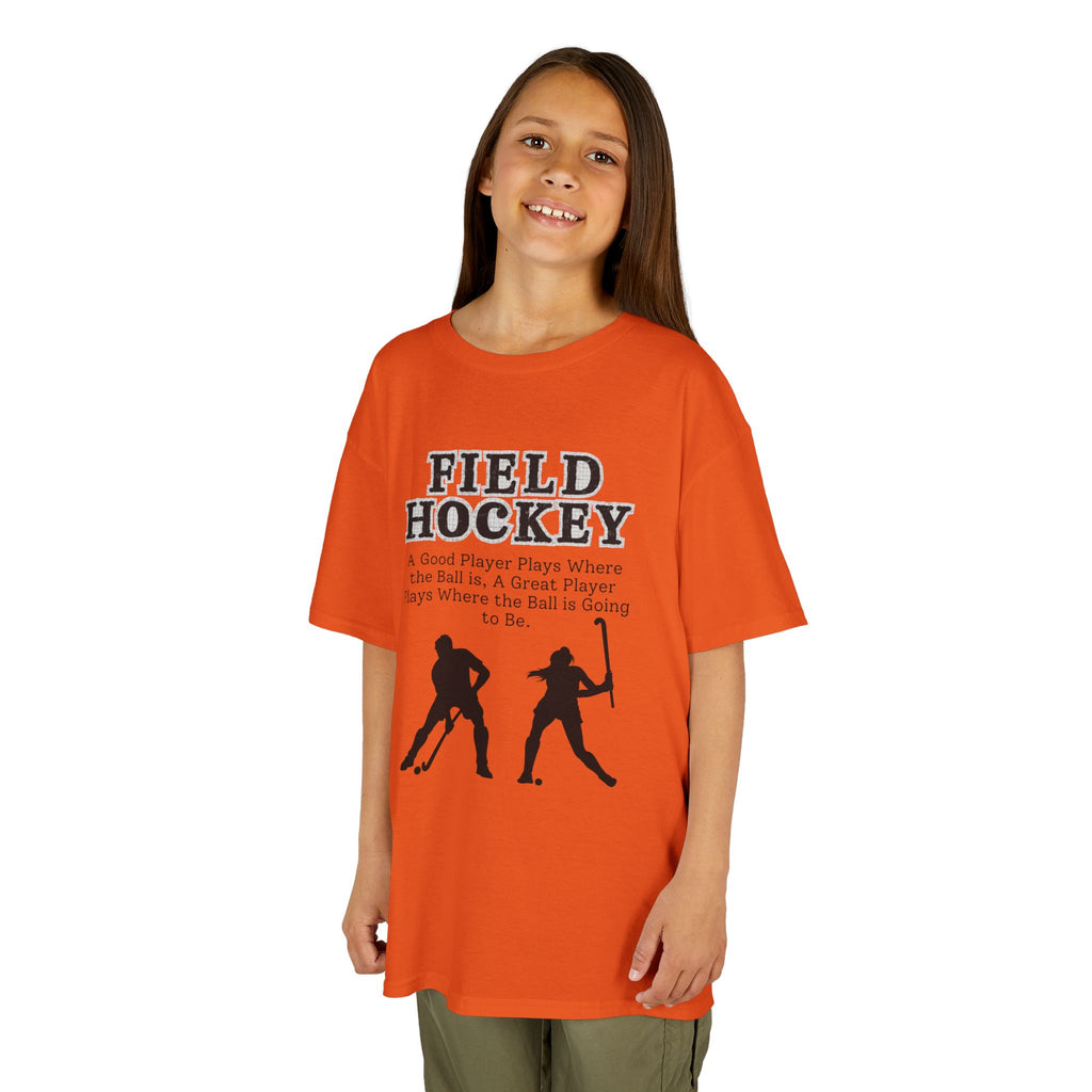 Young girl wearing a youth Gildan 5000B heavy cotton t-shirt in orange with a Field Hockey text and graphic