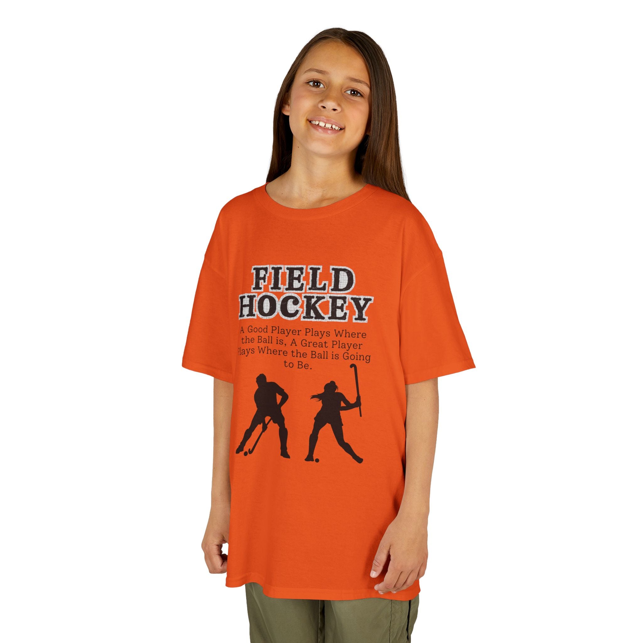 Young girl wearing a youth Gildan 5000B heavy cotton t-shirt in orange with a Field Hockey text and graphic