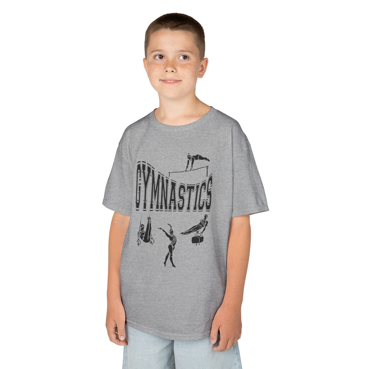 Young boy wearing a youth Gildan 5000B heavy cotton t-shirt in sport grey with a gymnastics text and graphic