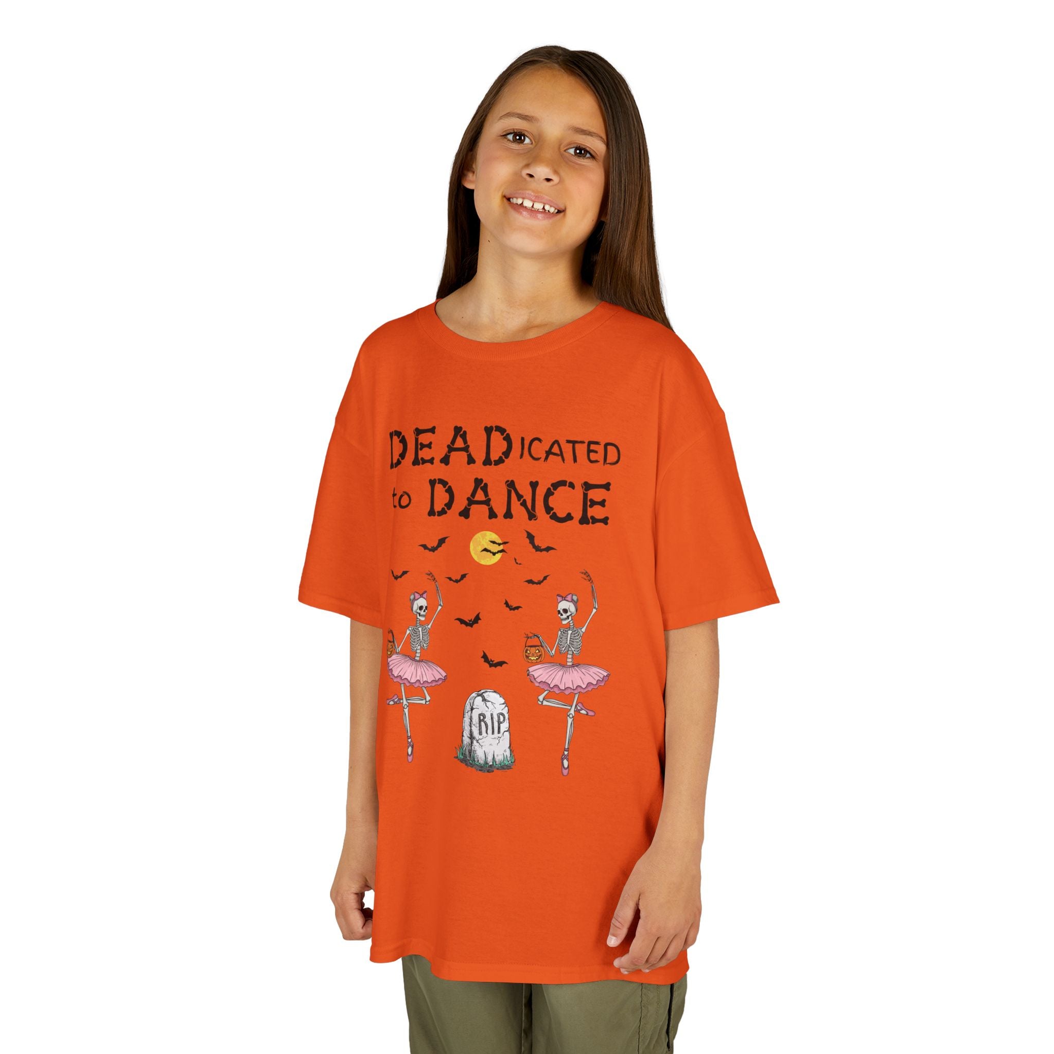 Young girl wearing a youth Gildan 5000B heavy cotton t-shirt in orange with a Deadicated to Dance Halloween theme