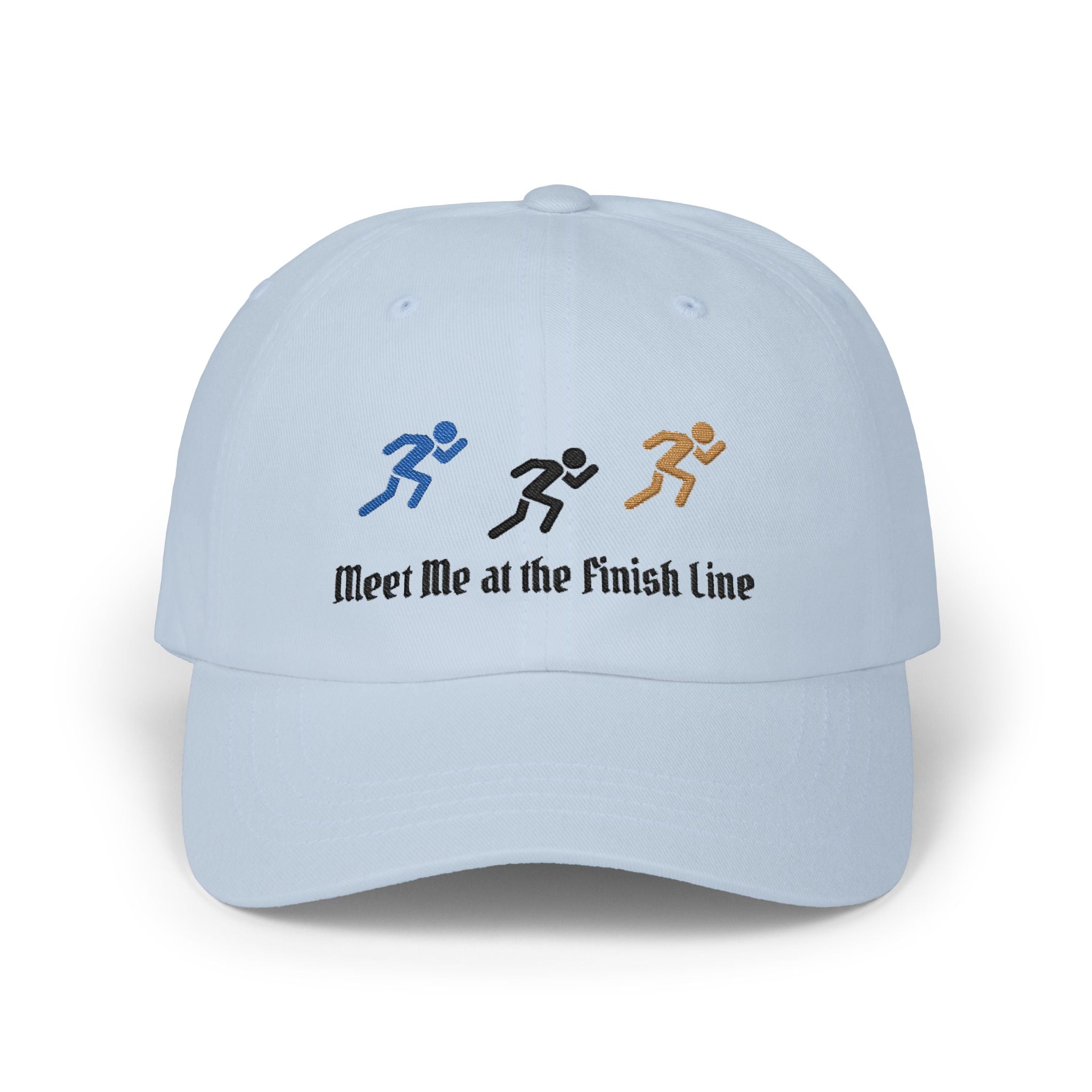 A light blue baseball cap featuring embroidered running figures in blue, black, and tan above the text Meet Me at the Finish Line.