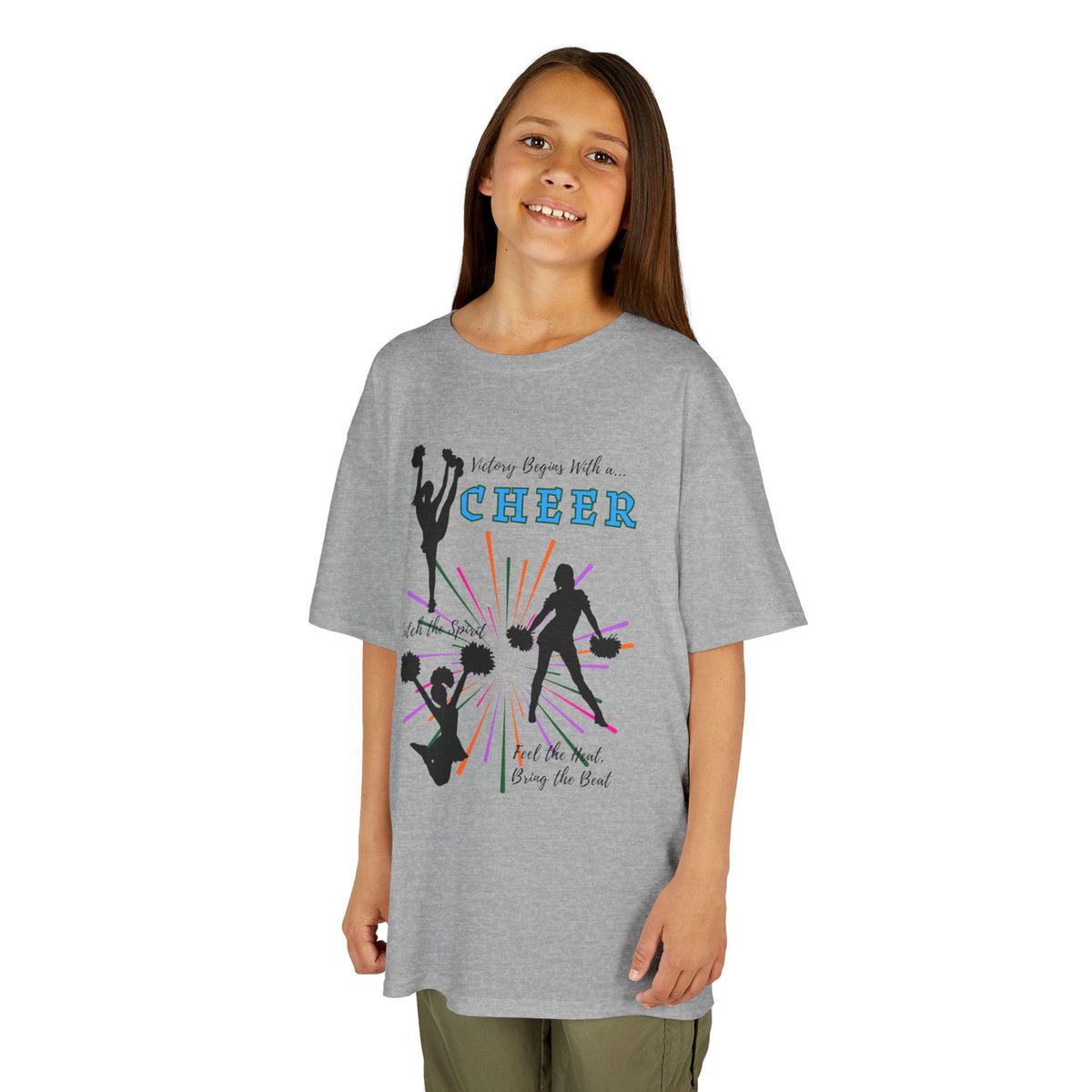 Young girl wearing a youth Gildan 5000B heavy cotton t-shirt in sport grey with a Cheer Team design