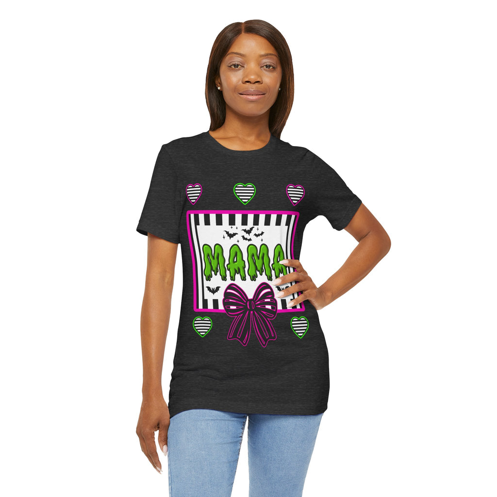 A woman wearing a dark grey t-shirt featuring a colorful Beetlejuice inspired Halloween-themed graphic with MAMA on the front.