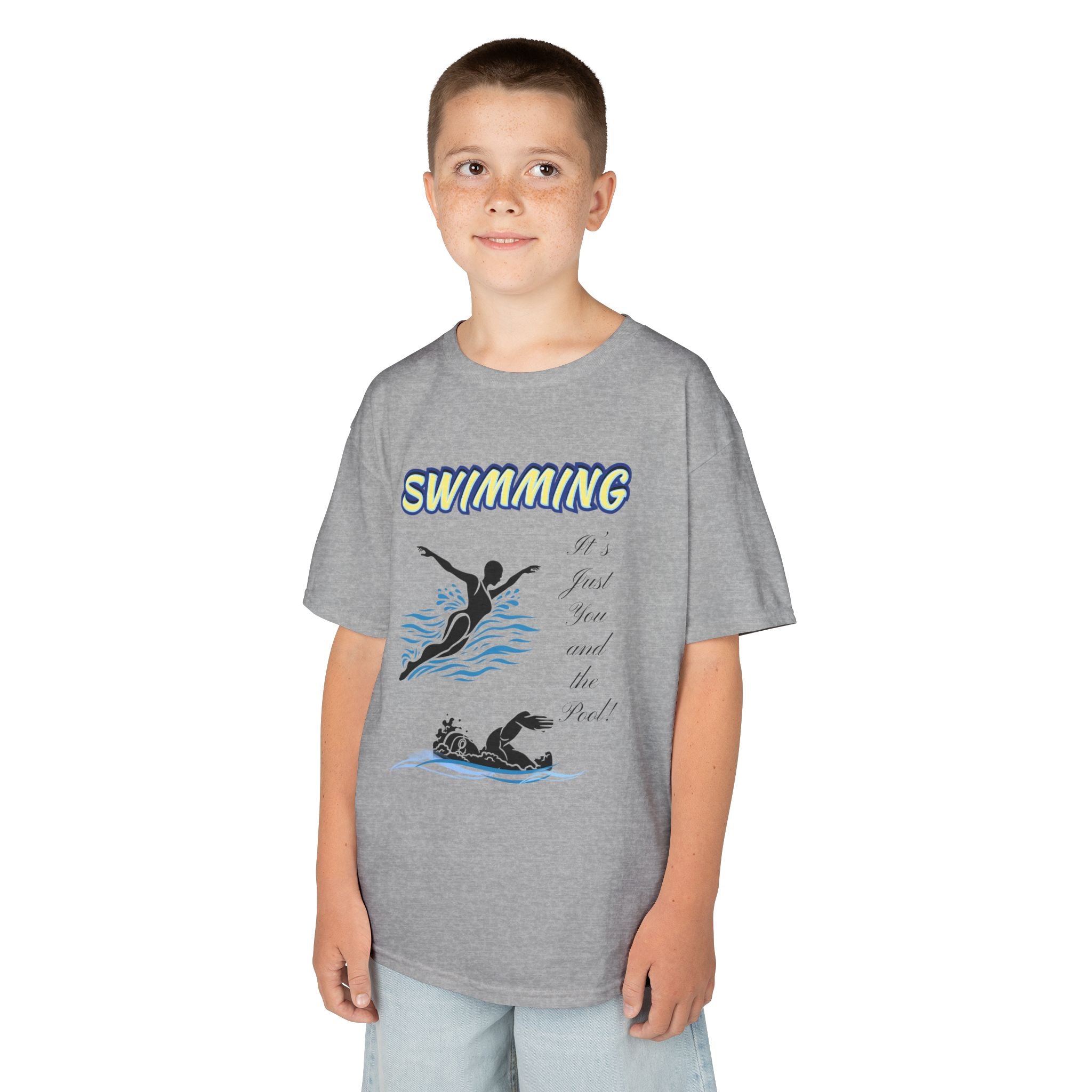 Young boy wearing a youth Gildan 5000B heavy cotton t-shirt in sport grey with a Swimming text and graphic
