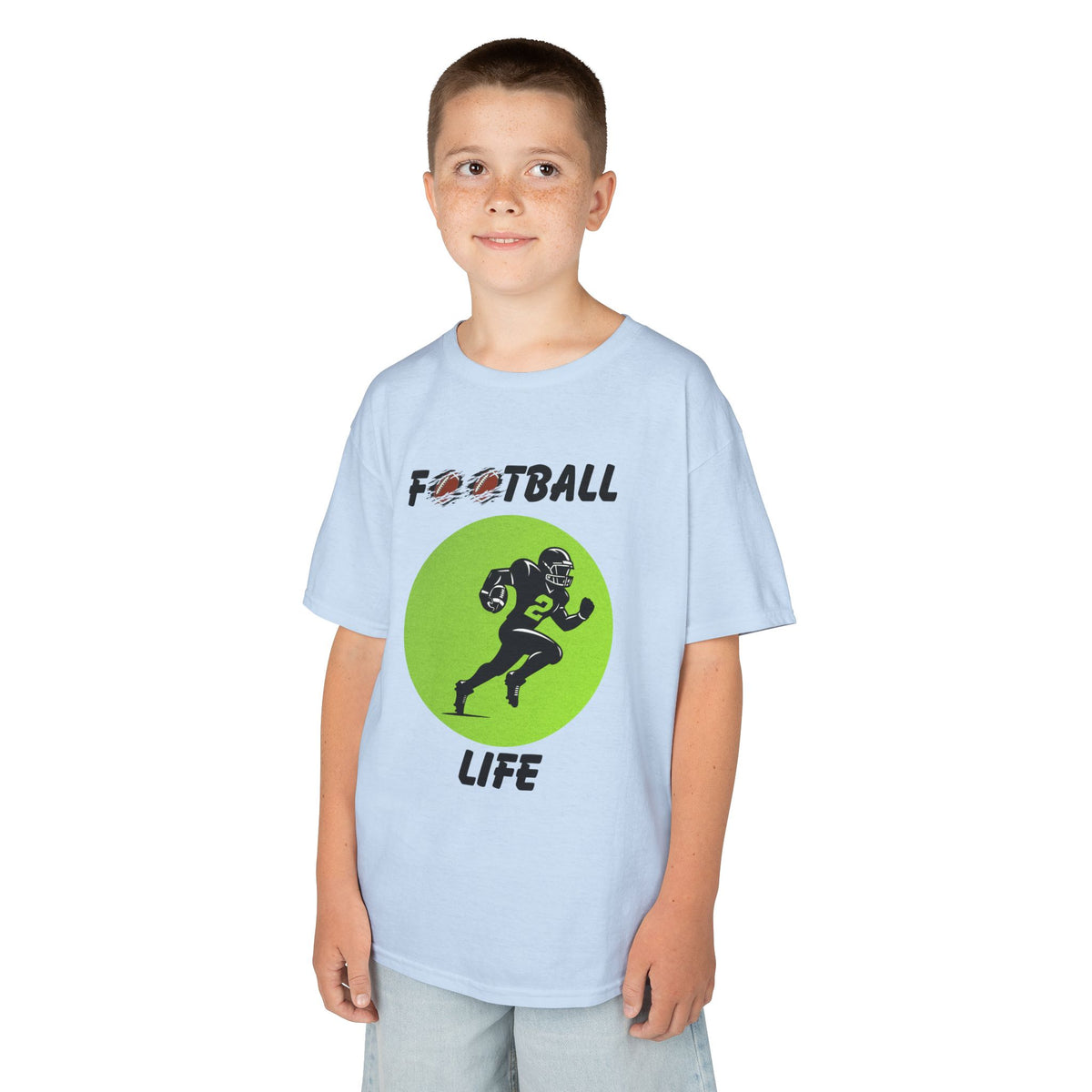 Young boy wearing a youth Gildan 5000B heavy cotton t-shirt in light blue with a Football Life text and graphic