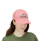 Woman wearing a pink cap with an embroidered soccer ball and Play Ball text on the front.