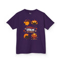 A kids purple short-sleeve t-shirt with a colorful graphic of cartoon turkeys and the phrase GOBBLE TIL YOU WOBBLE on the front.