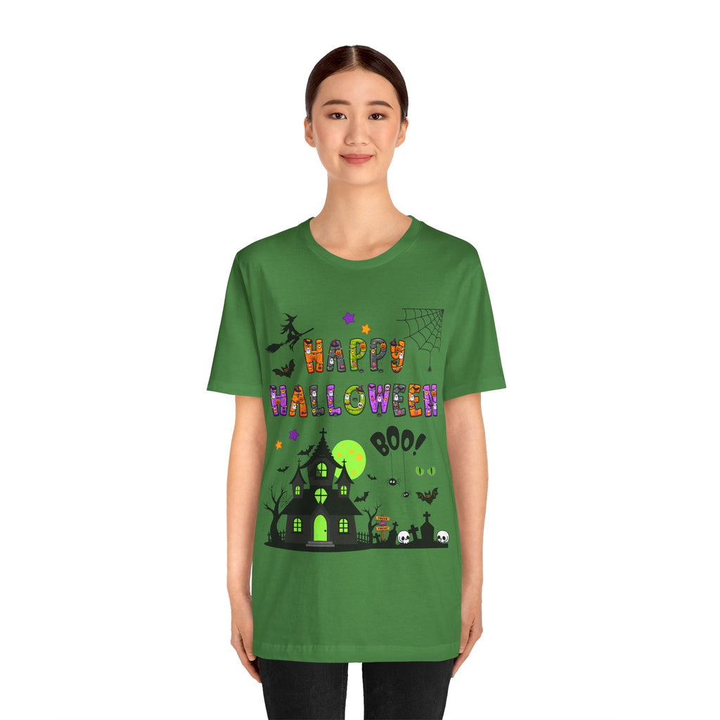 A woman wearing a green t-shirt with a colorful Happy Halloween text and haunted house design.