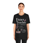 A young woman wearing a black short-sleeve crewneck t-shirt featuring a text that reads Dance Teacher and a ballet class graphic.
