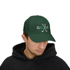 Man wearing a spruce cap embroidered with a GOLF text and golf club design.