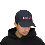 Man wearing a navy cap with an embroidered Band Life text.