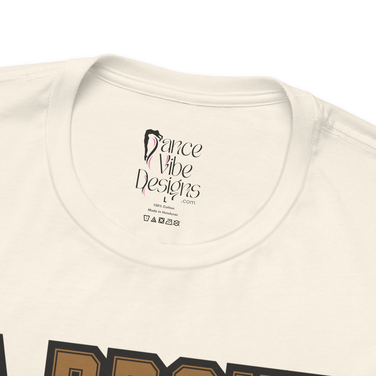Close-up of a natural crewneck t-shirt's inner neck label printed with the brand Dance Vibe Designs logo above the care instructions.