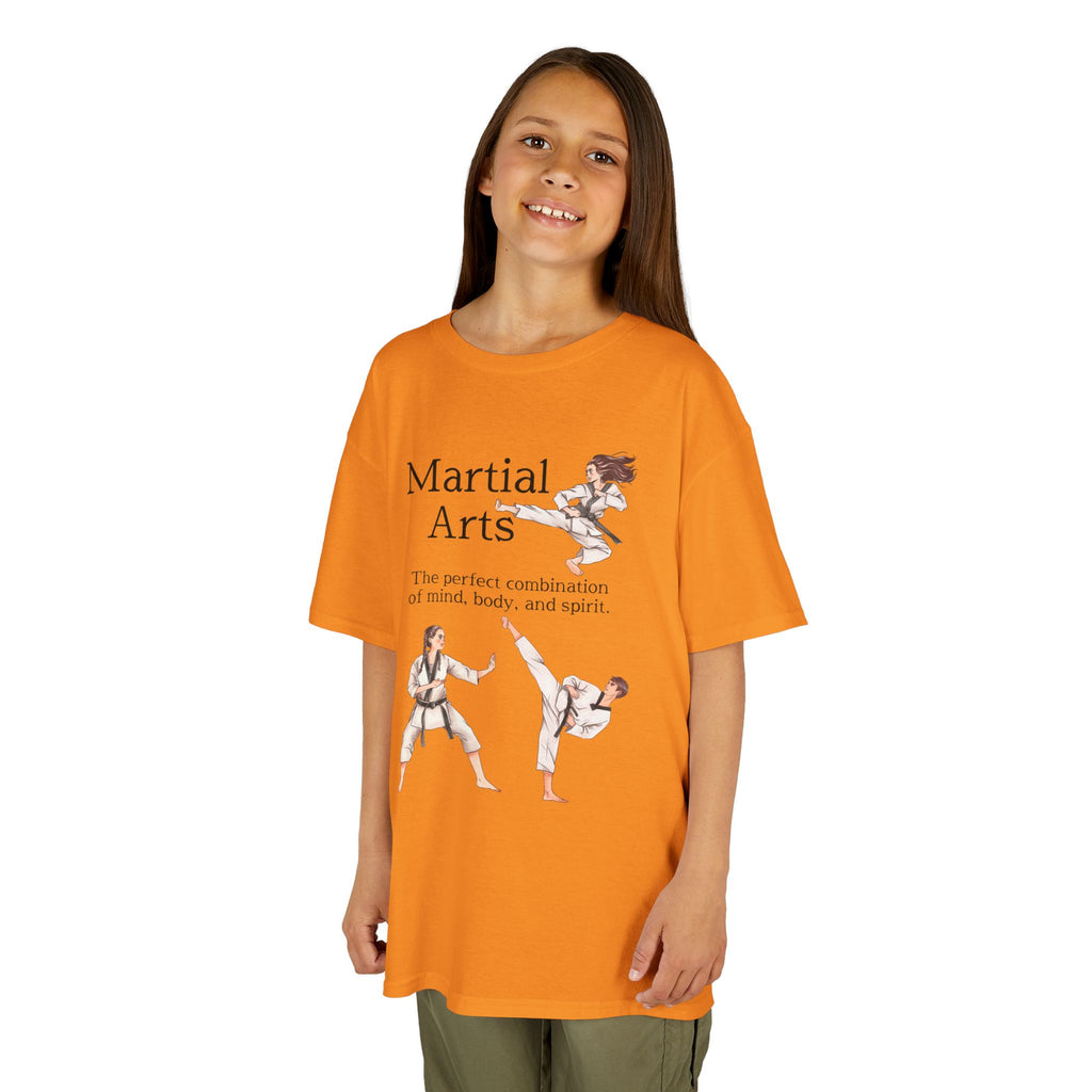 Young girl wearing a youth Gildan 5000B heavy cotton t-shirt in tennessee orange with a Martial Arts text and graphic