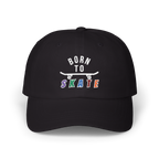 A black baseball cap featuring a graphic on the front that reads BORN TO SKATE with a skateboard illustration. 
