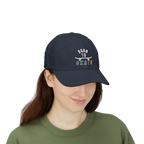 A woman wearing a navy baseball cap featuring a graphic on the front that reads BORN TO SKATE with a skateboard illustration. 